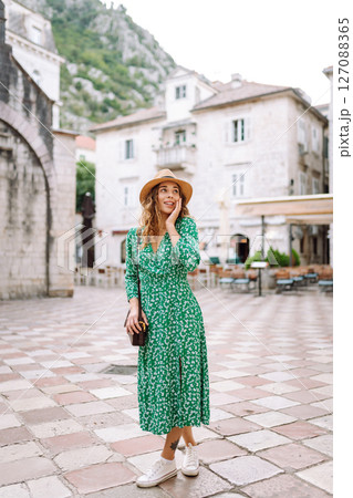 Young woman in beautiful dress walking in the street of the city. Eurotrip. Travel, tourism. Fashion Young woman in beautiful dress walking in the street of the city. Eurotrip. Travel, tourism. Fashion 127088365