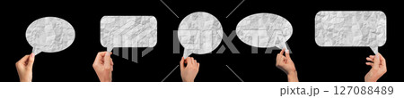 Hand holding a crumpled paper speech bubble, representing a conversation or chat. Concept of 127088489
