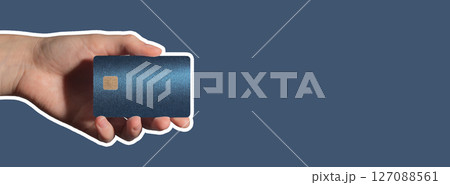 Colorful cashless concept. Hand holding bright plastic bankcard with chip in closeup for credit, 127088561