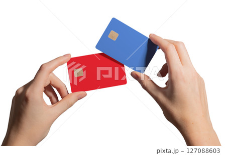 Colorful card concept. Hand holding two plastic bankcards in blue and red with chip for credit, 127088603
