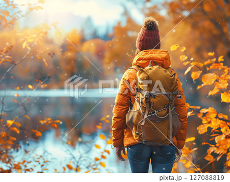 Happy woman traveler with backpack enjoying autumn hiking along the river. Active lifestyle concept. AI Generated. 127088819