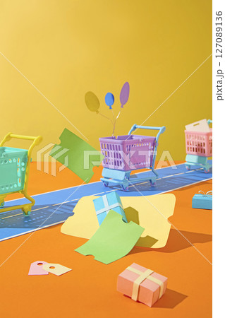 Lots of shopping themed items like carts, vouchers, packages are placed on a vibrant background, ideal for promoting big sale events with eye-catching images. 127089136
