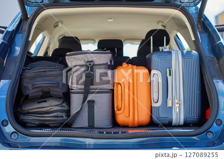 Full car trunk packed with suitcases, backpacks and bags. Vehicle filled with luggage ready for travel. Moving or road trip concept 127089255