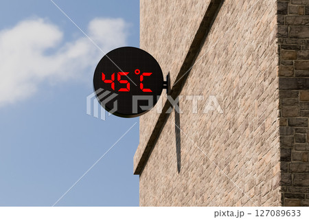 Street digital thermometer displaying a temperature of 45 degrees Celsius with blue sunny background. Street digital thermometer displaying a temperature of 45 degrees Celsius with blue sunny background. 127089633
