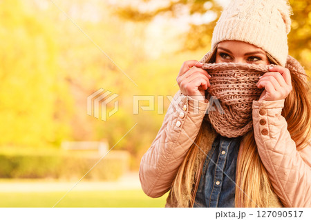 Girl hiding her face with scarf 127090517