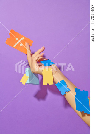 Hand holding a coupon, and vouchers stuck all over the arm on purple background. Illustrating an online storefront for digital marketing or shopping platform visuals. Hand holding a coupon, and vouchers stuck all over the arm on purple background. Illustrating an online storefront for digital marketing or shopping platform visuals. 127090657