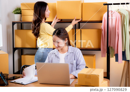 Two young asian businesswoman checking order of customer for laptop computer and document. Two young asian businesswoman checking order of customer for laptop computer and document. 127090829