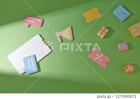 Flat design with multiple shopping themed items on a soft gradient background such as: coupons, purchase receipts, speakers, shopping bags, boxes. Illustrate consumer behavior or market trends 127090871