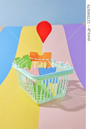 The colorful background is made of pastel paper strips, on which is placed a shopping cart filled with discount vouchers. composition ideal for holiday shopping campaigns. 127090876