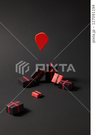 On a black background, mini paper gift boxes are decorated and randomly arranged. The black and red color scheme evokes the shopping theme during the big holiday Black Friday. 127091194