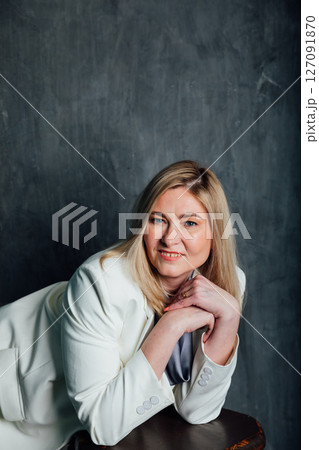 40 years old woman in white business suit at work 127091870