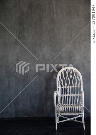 White armchair in the interior of a gray room White armchair in the interior of a gray room 127091947