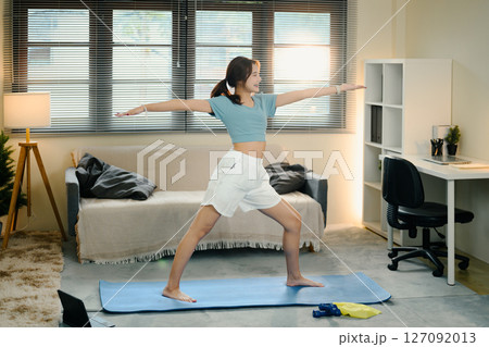Female practicing yoga in a relaxed home. Healthy lifestyle habits concept Female practicing yoga in a relaxed home. Healthy lifestyle habits concept 127092013