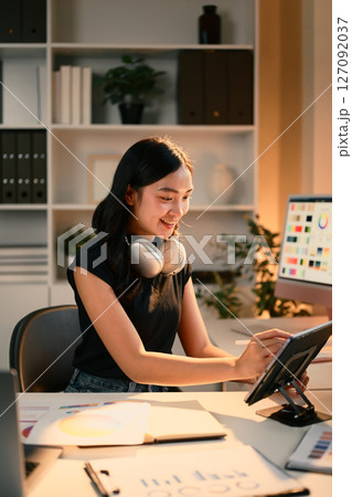 Designer woman working on branding project using digital tablet at modern creative office Designer woman working on branding project using digital tablet at modern creative office 127092037