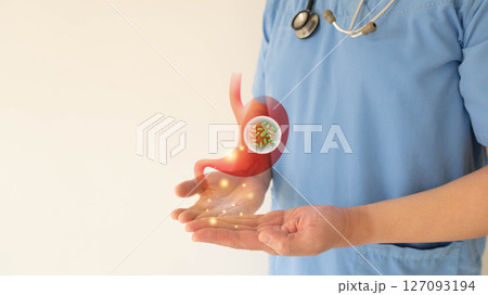 Gastroenterologist showing Helicobacter pylori bacteria infects human stomach. H.pylori infections may result in stomach inflammation (gastritis) and peptic ulcer disease. Gastroenterology concept. Gastroenterologist showing Helicobacter pylori bacteria infects human stomach. H.pylori infections may result in stomach inflammation (gastritis) and peptic ulcer disease. Gastroenterology concept. 127093194