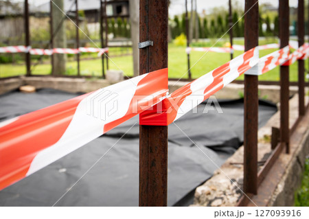 Construction Site with Red and White Caution Tape 127093916