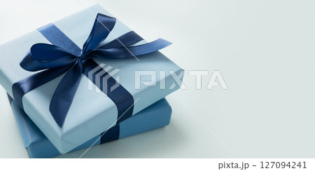 Banner with two blue gift boxes on pastel blue background. Greeting card, flyer or invitation. Close up. Copy space. Happy Fathers Day. Banner with two blue gift boxes on pastel blue background. Greeting card, flyer or invitation. Close up. Copy space. Happy Fathers Day. 127094241