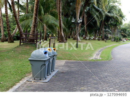 Row of plastic bins in nature public park. Row of plastic bins in nature public park. 127094693