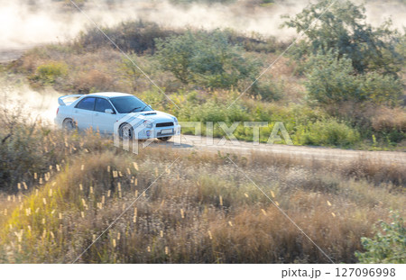 Rally Car After a Sharp Turn on a Dusty Road 127096998