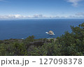 Aerial view of Roque de Garachico big rock in the ocean from Mirador de Garachico view point. Blue ocean with green vegetation. Popular tourist destination, Tenerife Canary Islands. 127098378
