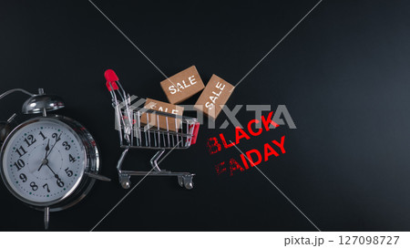 Discount events, Alarm clock and shopping cart with BLACK FRIDAY text, symbolizing time-sensitive sales, holiday shopping urgency and ecommerce promotions. retail marketing, and urgent deals. Discount events, Alarm clock and shopping cart with BLACK FRIDAY text, symbolizing time-sensitive sales, holiday shopping urgency and ecommerce promotions. retail marketing, and urgent deals. 127098727