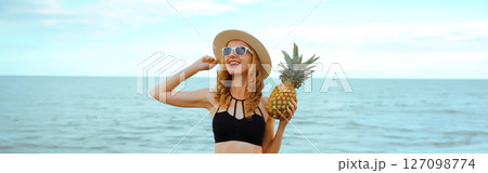Summer, happy smiling young woman, laughing, with fruits, having fun on the beach on sea background 127098774