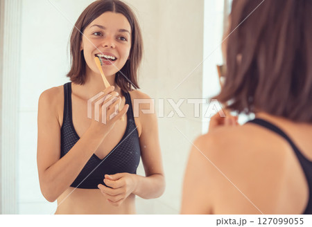 Young girl is cleaning her teeth. Young girl is cleaning her teeth. 127099055