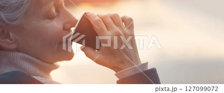 Portrait of a beautiful old lady with a coffee closeup. 127099072