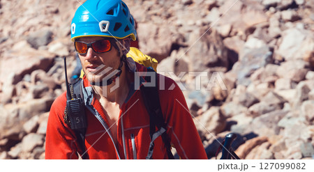 Man is climbing, hiking in the mountains. 127099082