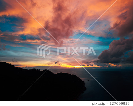 Orange and Teal Sunset Sky Over Tropical Sea Orange and Teal Sunset Sky Over Tropical Sea 127099933