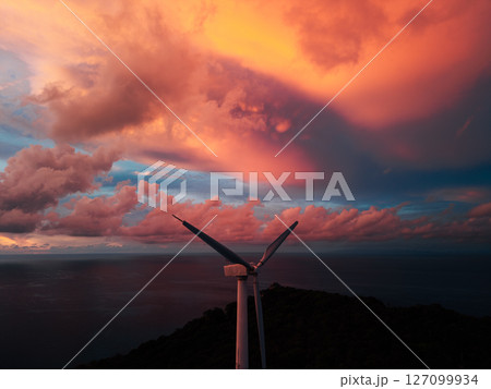 Wind Turbine Against a Fiery Sunset Sky 127099934