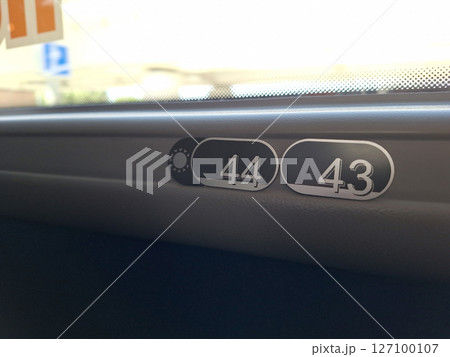 Close-up of train window seat numbers 44 and 43 in daylight 127100107