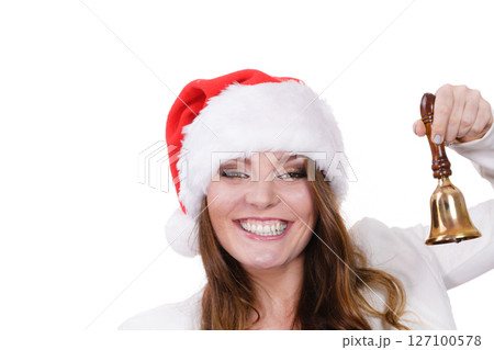 Woman in santa claus hat ringing a bell 127100578
