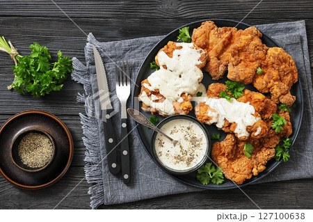 Deep fried Southern chicken thighs with milk gravy 127100638