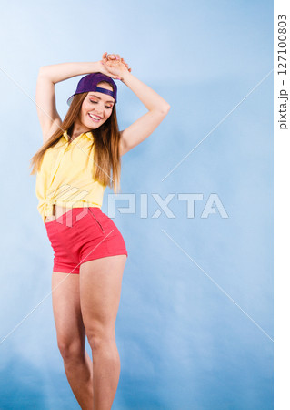 Woman casual style cap on head on blue. Fashion shot Woman casual style cap on head on blue. Fashion shot 127100803