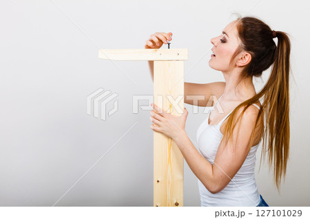 Woman assembling wooden furniture. DIY. Woman assembling wooden furniture. DIY. 127101029