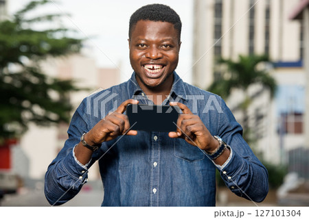 young happy man holding a smart phone 127101304