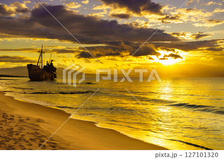 Rusty broken shipwreck on sea shore Rusty broken shipwreck on sea shore 127101320