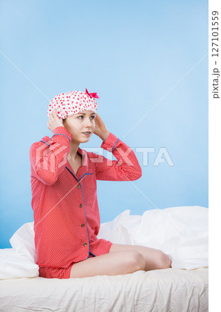 Funny woman wearing pajamas and bathing cap Funny woman wearing pajamas and bathing cap 127101559