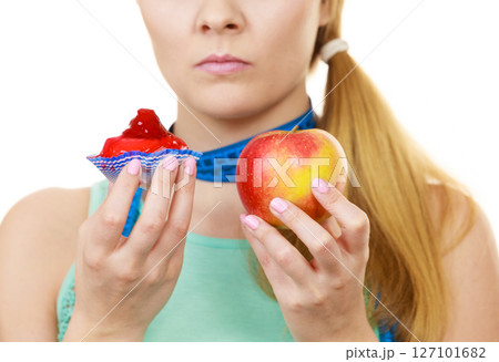 Woman choosing fruit or cake make dietary choice Woman choosing fruit or cake make dietary choice 127101682