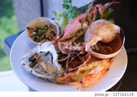 table set with assorted appetizers, seafood, and pastries for festive meal table set with assorted appetizers, seafood, and pastries for festive meal 127102119