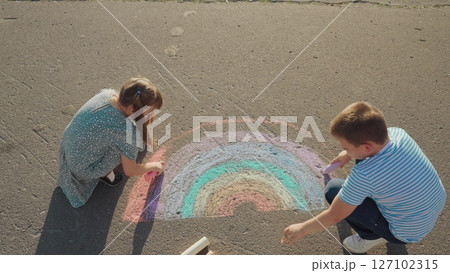 Kid child baby boy girlColourful chalk project, children drawing rainbow, art on street, evening fun, warm weather play, kids sketching, team creativity, summer artist kids, rainbow ground art 127102315