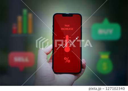 hand holding smartphone with financial charts 127102340