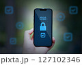 hand holding smartphone with security lock 127102346