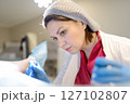 Gynecologist examines a patient laying on gynecological chair using medical vaginal speculum. Doctor takes pap smear test from a young woman cervix. Diagnosis of diseases. Woman reproductive health. 127102807