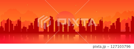 City panorama at sunset with silhouetted buildings against a vibrant orange sky 127103796
