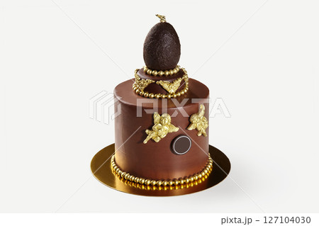 Delicious chocolate cake decorated with golden chocolate angels and egg topper Delicious chocolate cake decorated with golden chocolate angels and egg topper 127104030