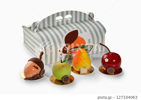 Fruit shaped desserts in front of pastry box from the braun family 127104063