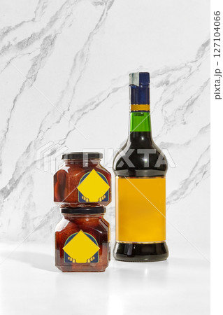 Baba preserving jars and borsci elixir bottle displayed on white marble surface 127104066
