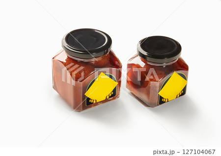 Two jars of baba al rhum showing preserved cherries in rum syrup on white background Two jars of baba al rhum showing preserved cherries in rum syrup on white background 127104067